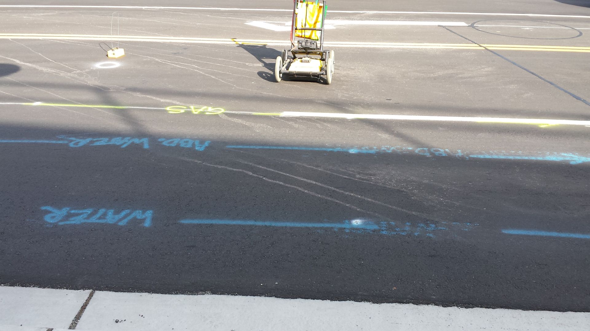 A parking lot with a street sweeper on the side of it